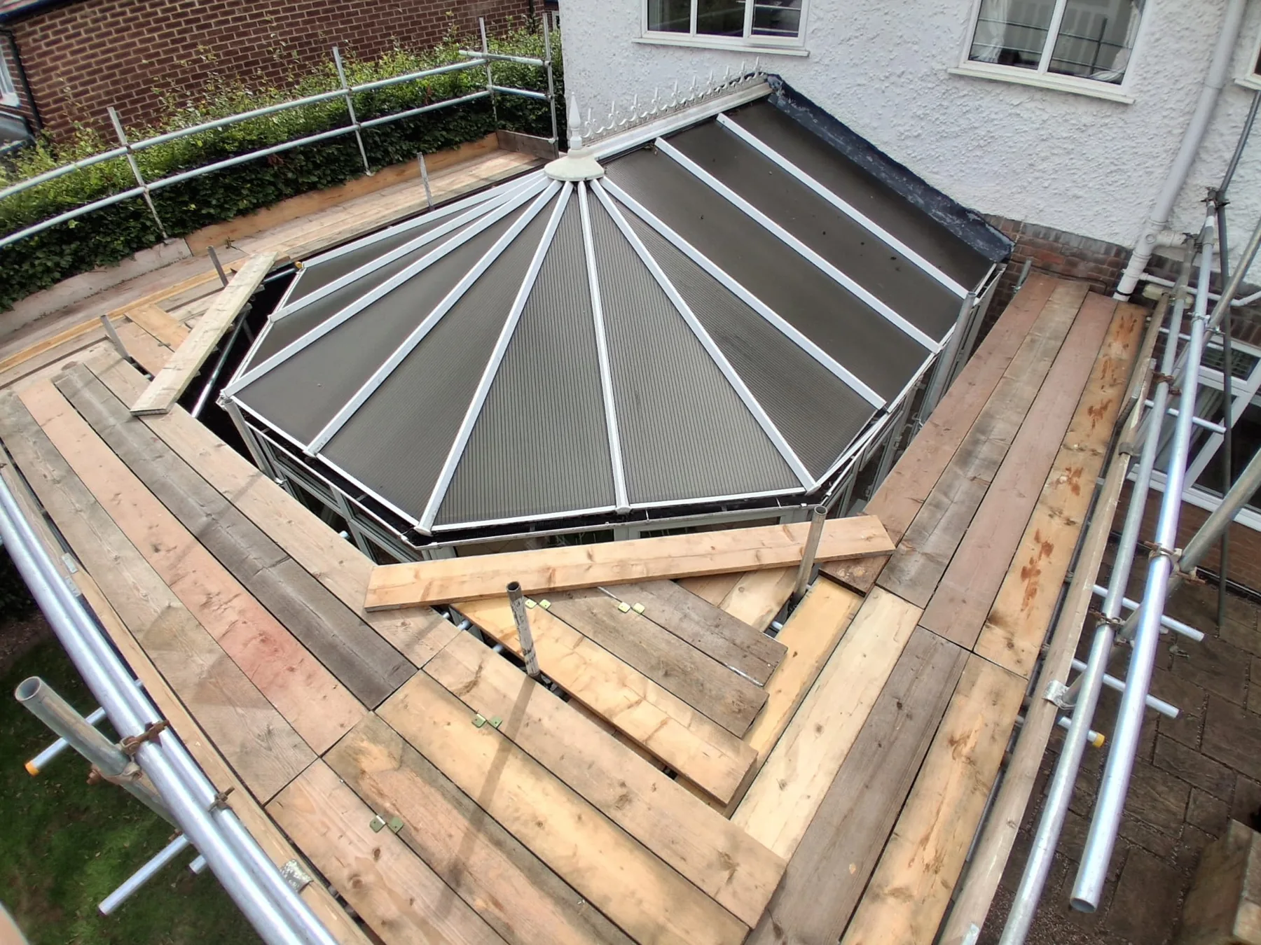 Scaffold platforms installed around a conservatory roof