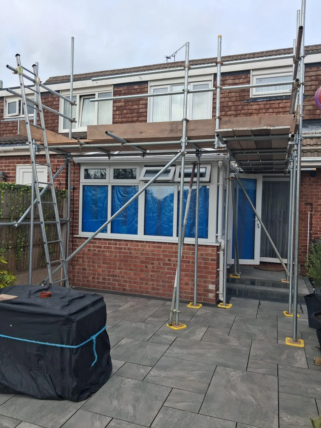 Scaffold platform installed across the front of a house